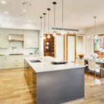 Kitchen with Island, Sink, Cabinets, and Hardwood Floors